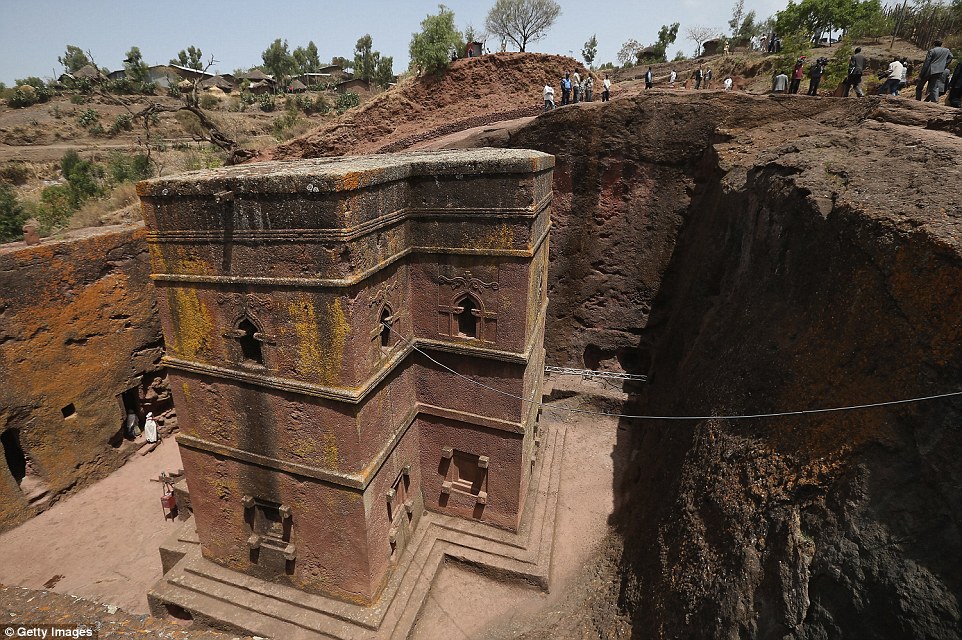 Visitors walk past Bete Giyorgis, also called St George's Church, at the Lalibela holy site. Irish tour operator Tony Hickey who arrived in Ethiopia in 1973 told The Daily Mail how Ethiopia differs from popular destinations Kenya and Tanzania. 
