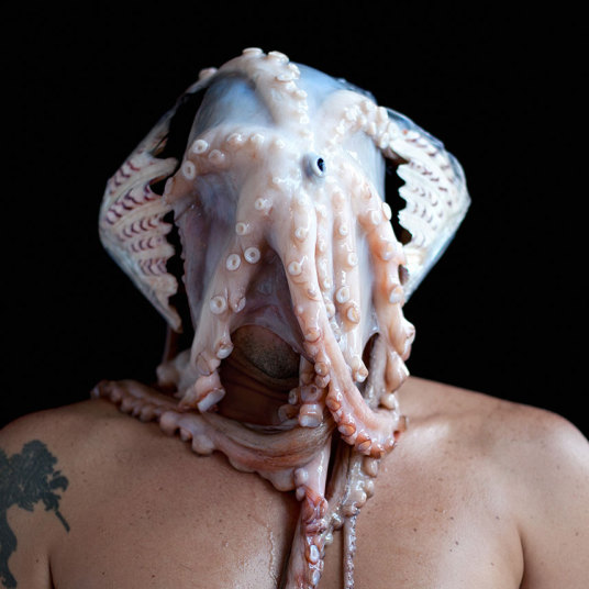 Rio de Janeiro artist Edu Monteiro surround his head with objects ranging from cigarettes and bananas to cabbage and an octopus.Credit: Edu Monteiros