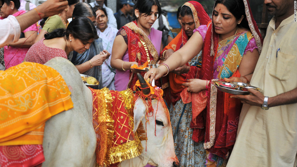 Beef ban: women place beads on a holy cow