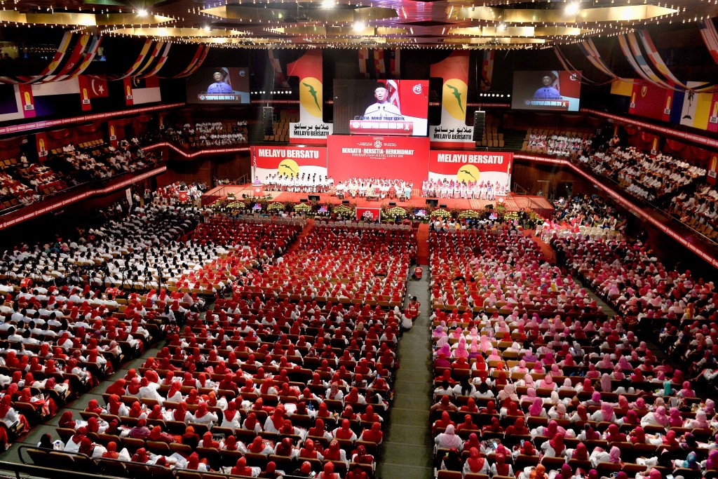 Delegates from Pemuda, Wanita and Puteri hear Deputy Prime Minister Tan Sri Muhyiddin Yassin delivers a speech during the opening of the general assembly of the Wanita, Youth and Puteri Umno in conjunction UMNO General Assembly 2014 at Putra World Trade Centre, Kuala Lumpur. Umno General Assembly this year takes place from 25 to 29 November. Adib Rawi Yahya/theSun